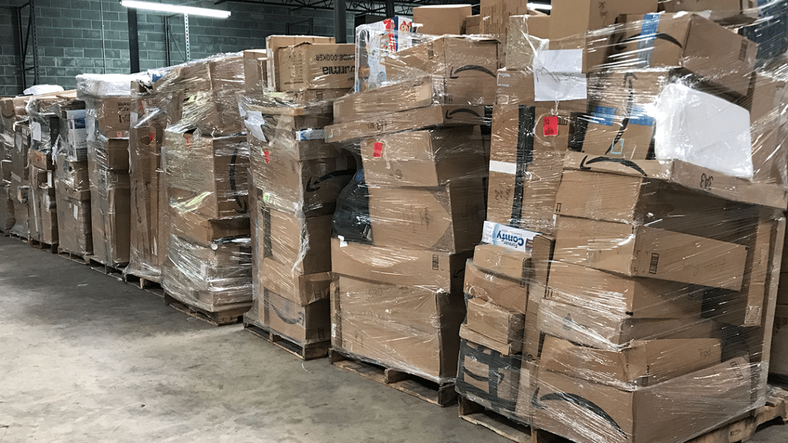 Amazon return pallets and crates in a warehouse.